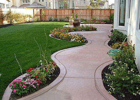 Custom sidewalk with flower beds incorporated into design